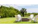 Charming outdoor fire pit surrounded by Adirondack chairs, perfect for enjoying cool evenings in the yard at 2906 Palm Blvd, Isle of Palms, SC 29451