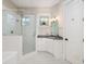 Clean bathroom featuring a glass shower, white cabinets, and checkered tile flooring at 2906 Palm Blvd, Isle of Palms, SC 29451