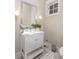 Bathroom featuring a modern vanity with mirror, decorative tile, and a window at 2906 Palm Blvd, Isle of Palms, SC 29451