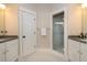 Bathroom with white cabinets, dual sinks, and a glass-enclosed shower at 2906 Palm Blvd, Isle of Palms, SC 29451