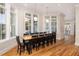 Bright dining room features large windows, modern lighting, and hardwood floors at 2906 Palm Blvd, Isle of Palms, SC 29451