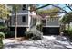 Charming gray home with red accents, landscaped yard, and covered entry at 2906 Palm Blvd, Isle of Palms, SC 29451