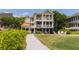 Charming multi-story beach house with a spacious lawn, outdoor gazebo, and well-manicured landscaping at 2906 Palm Blvd, Isle of Palms, SC 29451