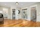 Foyer with hardwood flooring, open doorways to the bathroom and bedroom, and natural light at 2906 Palm Blvd, Isle of Palms, SC 29451