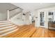 Inviting foyer featuring hardwood floors, staircase, and ample natural light at 2906 Palm Blvd, Isle of Palms, SC 29451
