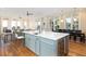 Open floor plan with kitchen island, wine refrigerator, and views of living and dining areas at 2906 Palm Blvd, Isle of Palms, SC 29451