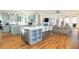 Open-concept kitchen with large island, modern appliances, and living area at 2906 Palm Blvd, Isle of Palms, SC 29451