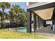 Private pool area with a black fence, covered patio, and chairs for relaxation at 2906 Palm Blvd, Isle of Palms, SC 29451