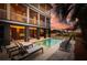 Relaxing poolside retreat with lounge chairs, lush tropical landscaping, and evening ambiance at 2906 Palm Blvd, Isle of Palms, SC 29451