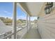 Charming balcony with white columns overlooking a scenic pond and neighborhood, perfect for relaxing outdoors at 3073 Moonlight Dr, Charleston, SC 29414