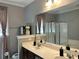 Bathroom featuring double sinks, a large mirror, and walk-in shower at 3073 Moonlight Dr, Charleston, SC 29414