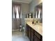 Neutral bathroom featuring a double sink, large mirror, and decorative curtains at 3073 Moonlight Dr, Charleston, SC 29414