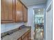Convenient butler's pantry features granite countertops and ample cabinet space for storage and serving at 3073 Moonlight Dr, Charleston, SC 29414
