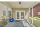Covered porch features a concrete surface, siding, and an entry door leading to the exterior of the house at 3073 Moonlight Dr, Charleston, SC 29414