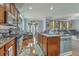 Open kitchen with a center island with seating, stainless steel appliances and hardwood floors at 3073 Moonlight Dr, Charleston, SC 29414