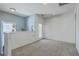 Bright loft area with carpeting, door to the porch, and plenty of natural light from the windows at 3073 Moonlight Dr, Charleston, SC 29414