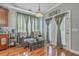 Cozy sitting area features comfortable wicker chairs, a warm chandelier, and french doors that lead to a porch at 3073 Moonlight Dr, Charleston, SC 29414