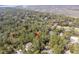 Aerial view of a home nestled amongst trees near a golf course and marshland at 3180 Pine Needle Ln, Seabrook Island, SC 29455