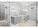 Bathroom featuring dual sink vanity with granite countertops and a large mirror at 3180 Pine Needle Ln, Seabrook Island, SC 29455