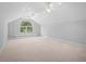A large, carpeted bonus room features a vaulted ceiling, a unique arched window and recessed lighting at 3180 Pine Needle Ln, Seabrook Island, SC 29455