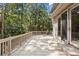 Large outdoor wooden deck surrounded by lush trees, providing a serene outdoor living space at 3180 Pine Needle Ln, Seabrook Island, SC 29455