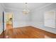 Dining room featuring hardwood floors, wainscoting, chandelier, and natural light at 3180 Pine Needle Ln, Seabrook Island, SC 29455