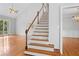 Bright entryway featuring a staircase, wood floors, and an open floor plan leading to multiple rooms at 3180 Pine Needle Ln, Seabrook Island, SC 29455