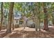 Charming home nestled among mature trees, featuring a welcoming entrance and neutral siding at 3180 Pine Needle Ln, Seabrook Island, SC 29455
