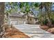 Home exterior featuring a two-car garage, neutral siding, and a paved driveway at 3180 Pine Needle Ln, Seabrook Island, SC 29455