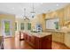 Well-lit kitchen featuring granite countertops, a center island, custom cabinets, and stainless steel appliances at 3180 Pine Needle Ln, Seabrook Island, SC 29455