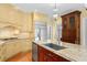 Detailed view of the kitchen island, showcasing granite countertops, a stainless steel sink, and custom cabinets at 3180 Pine Needle Ln, Seabrook Island, SC 29455