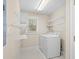 Functional laundry room with appliances, shelving and natural light from a window at 3180 Pine Needle Ln, Seabrook Island, SC 29455