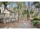 Rear exterior view featuring a deck and lush, mature landscaping at 3180 Pine Needle Ln, Seabrook Island, SC 29455