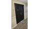 Apartment 7E entrance with dark wood door, hallway carpeting, and unit number display at 330 Concord St # 7E, Charleston, SC 29401