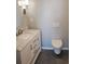 Modern bathroom featuring a marble countertop vanity and a sleek, wall-mounted toilet at 330 Concord St # 7E, Charleston, SC 29401