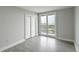 Bright bedroom with light gray walls, hardwood flooring, and access to a balcony at 330 Concord St # 7E, Charleston, SC 29401