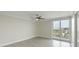 Bright bedroom with a ceiling fan, light walls, and balcony access at 330 Concord St # 7E, Charleston, SC 29401