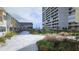 Beautifully landscaped courtyard featuring manicured lawn, lush greenery, and communal seating areas at 330 Concord St # 7E, Charleston, SC 29401