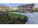 Tranquil courtyard with synthetic lawn, inviting seating, and lush landscaping for relaxation and community at 330 Concord St # 7E, Charleston, SC 29401