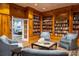 Cozy library with extensive built-in bookshelves, comfortable seating, and warm wood paneling at 330 Concord St # 7E, Charleston, SC 29401