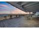 Picturesque covered patio with sunset views over the waterfront and comfortable seating at 330 Concord St # 7E, Charleston, SC 29401
