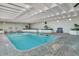 Indoor pool with brick trim, clear blue water, and comfortable lounge chairs at 330 Concord St # 7E, Charleston, SC 29401