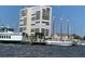 Scenic waterfront featuring docked sailboats, a modern high-rise, and a charming ferry boat at 330 Concord St # 7E, Charleston, SC 29401
