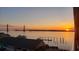 Scenic waterfront view featuring a bridge, calm waters, and a radiant sunrise in the distance at 330 Concord St # 7E, Charleston, SC 29401