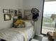 Cozy bedroom with a twin bed, bright pillows, and a lovely balcony view at 330 Concord St # 9C, Charleston, SC 29401
