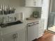 Modern kitchen features all white cabinets and stainless steel appliances at 330 Concord St # 9C, Charleston, SC 29401
