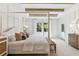 Serene main bedroom with a four-poster bed, white bedding, and ample natural light, creating a relaxing retreat at 355 Claret Cup Way, Charleston, SC 29414
