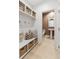 Well-organized mudroom with built-in storage, a bench, and a view of the adjacent powder room, perfect for busy families at 355 Claret Cup Way, Charleston, SC 29414