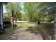 Expansive backyard showing the patio, open grass, and a peaceful wooded perimeter at 3708 Colonel Vanderhorst Cir, Mount Pleasant, SC 29466