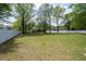 Large backyard featuring a level, grassy area, enclosed by a bright white fence at 3708 Colonel Vanderhorst Cir, Mount Pleasant, SC 29466